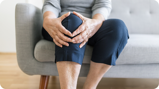 Close up of someone sitting down holding knee